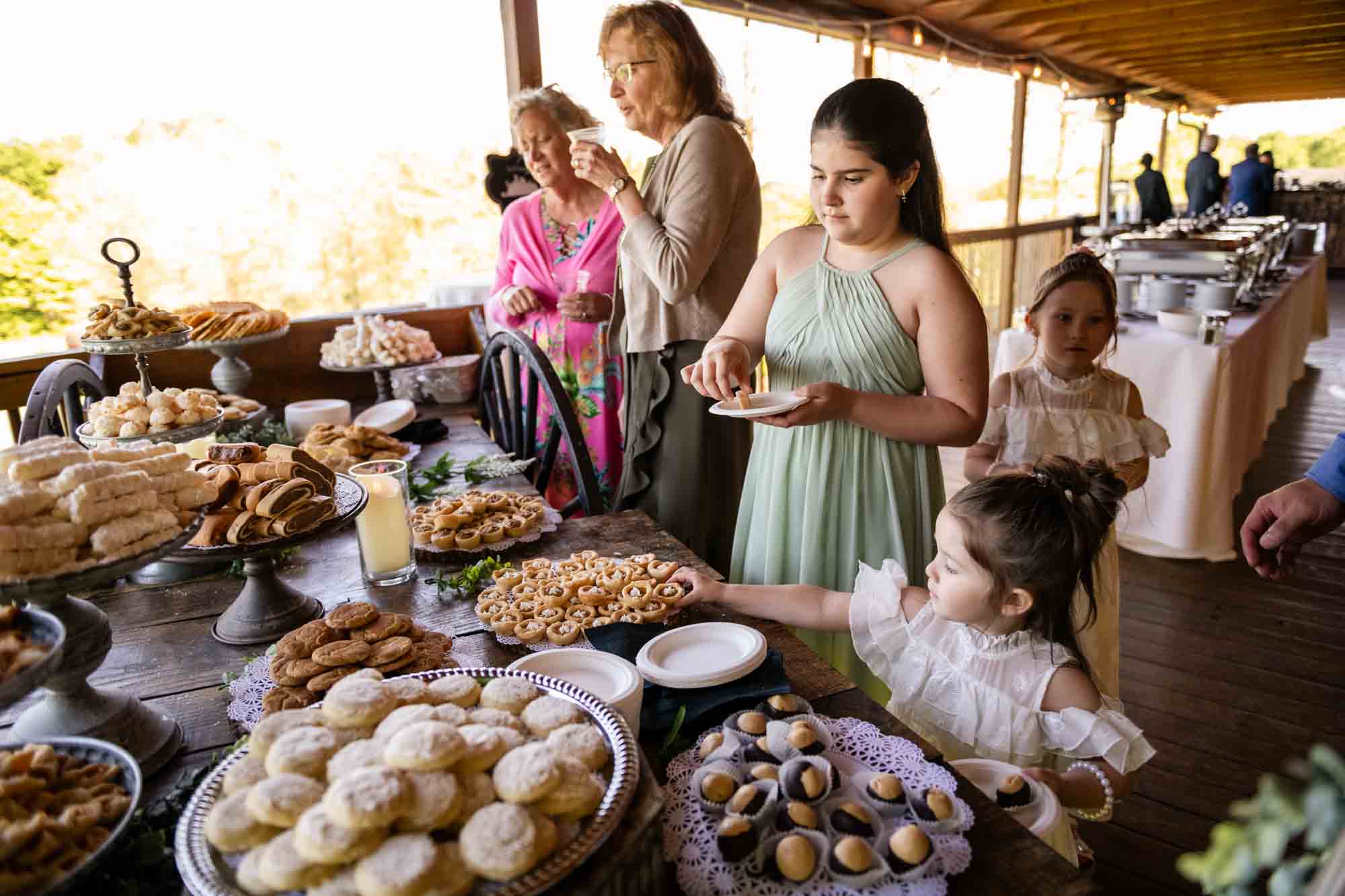 guests collect cookies from the Pittsburgh cookie table at the wedding reception at pinehall at eisler farm